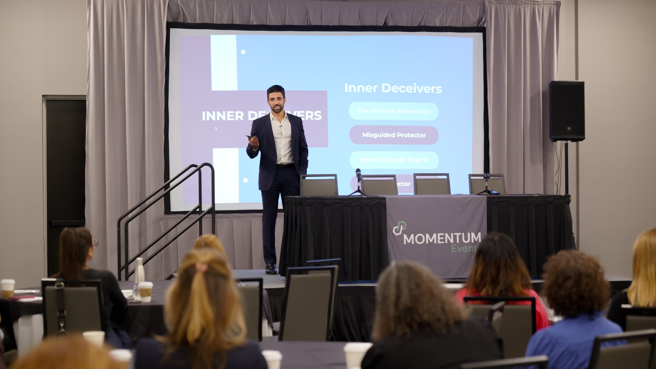Jonathan Z. Cohen delivering a keynote from the stage, teaching the Inner Deceivers framework to a live professional audience